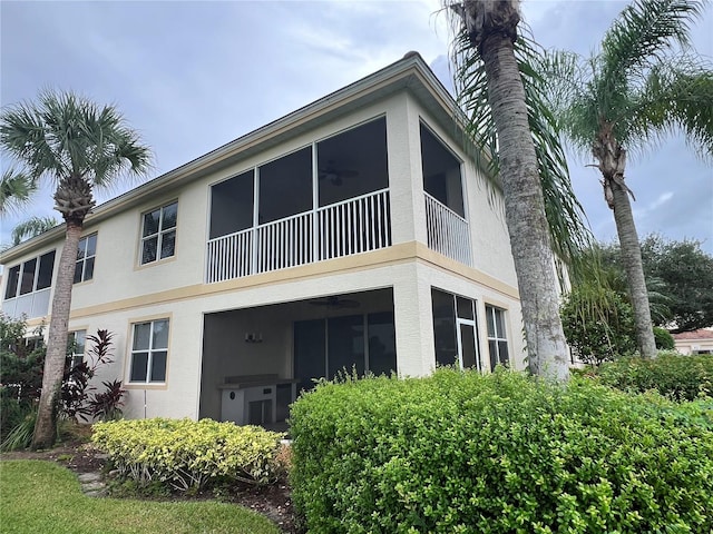 back of house with ceiling fan