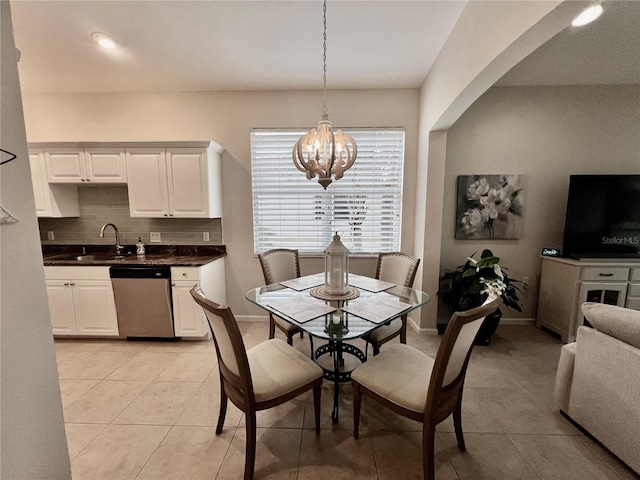 dining area featuring light tile patterned floors, an inviting chandelier, and sink