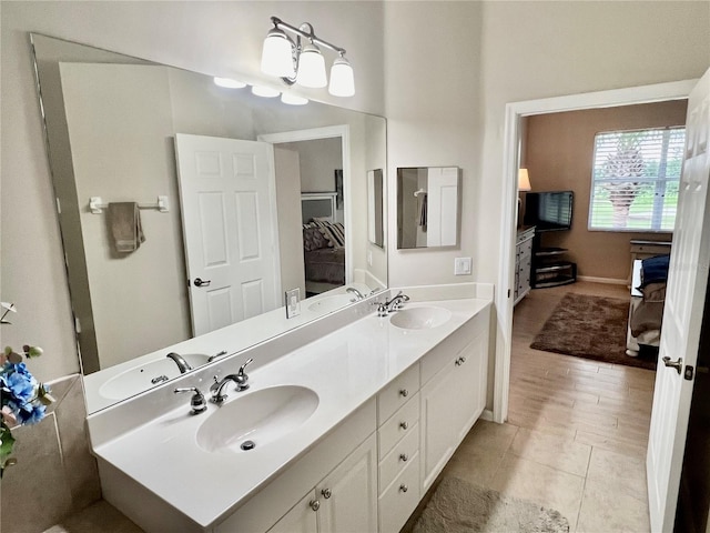 bathroom featuring vanity, an inviting chandelier, and tile patterned floors