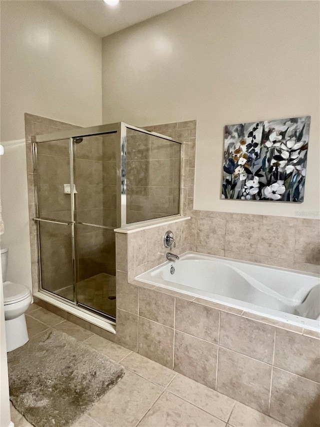 bathroom featuring tile patterned flooring, plus walk in shower, and toilet