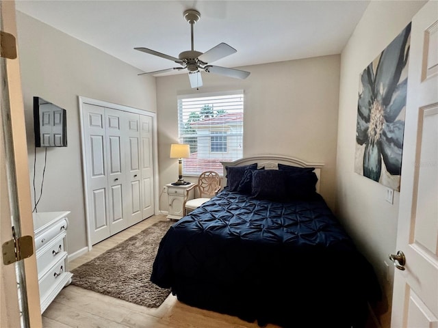 bedroom with ceiling fan, a closet, and light hardwood / wood-style floors