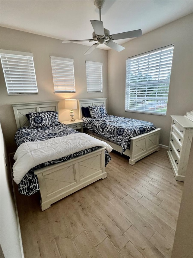 bedroom with ceiling fan and light hardwood / wood-style flooring