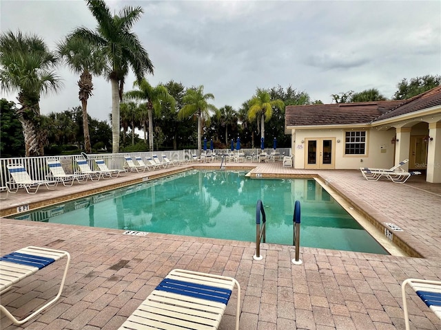 view of pool featuring a patio area and french doors