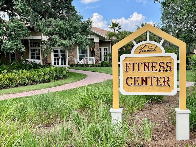 community / neighborhood sign with a lawn