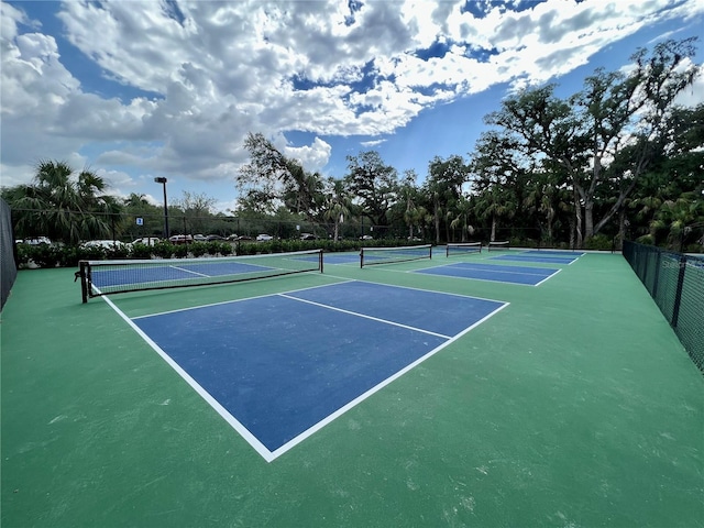 view of tennis court featuring fence