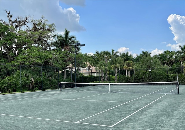 view of tennis court with fence