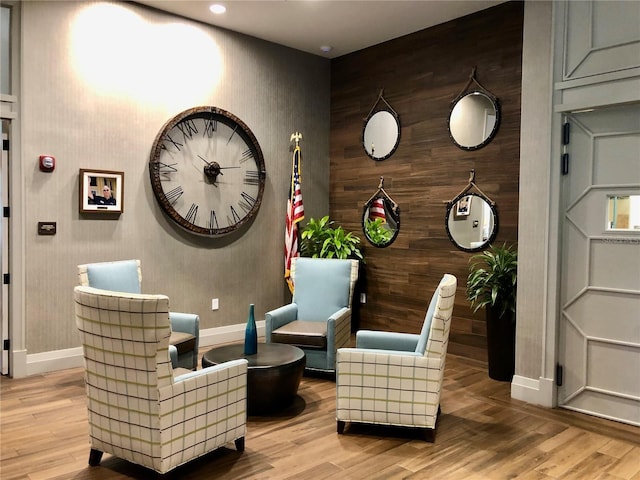 living area featuring light wood-type flooring and baseboards