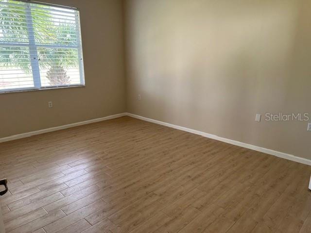 unfurnished room with hardwood / wood-style floors