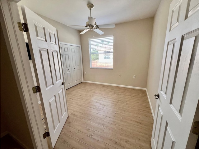 unfurnished bedroom with ceiling fan and light hardwood / wood-style floors