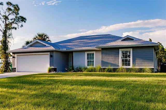 ranch-style home with a garage and a front lawn