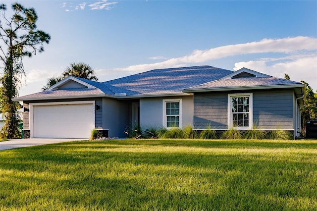 ranch-style home featuring an attached garage, driveway, and a front yard