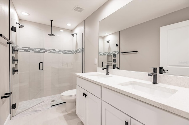 bathroom with tile patterned flooring, toilet, double vanity, and an enclosed shower