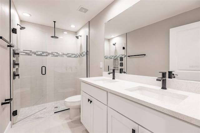 bathroom with double vanity, a stall shower, a sink, and visible vents