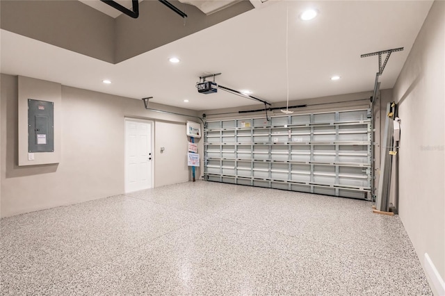 garage featuring recessed lighting, electric panel, and a garage door opener