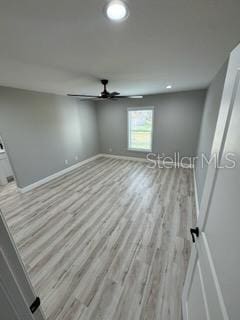 spare room with baseboards, wood finished floors, recessed lighting, and ceiling fan