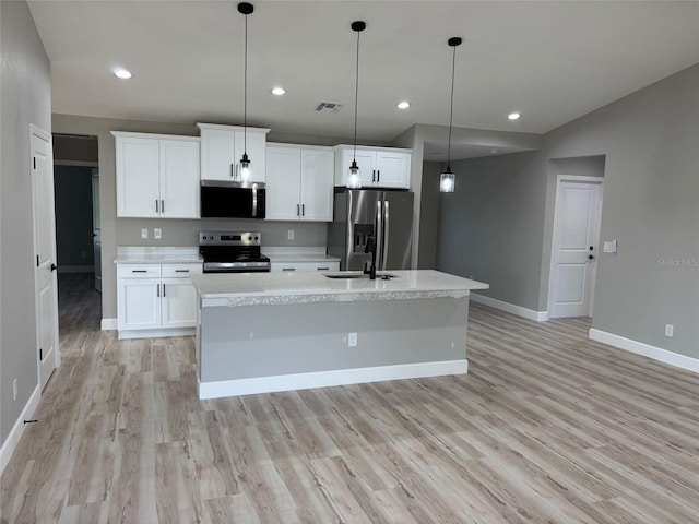 kitchen with light countertops, visible vents, baseboards, and stainless steel appliances