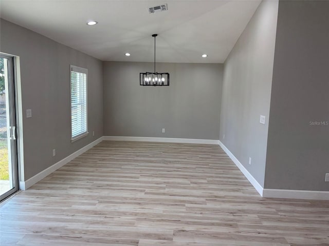 unfurnished dining area featuring light wood-type flooring, visible vents, and a wealth of natural light