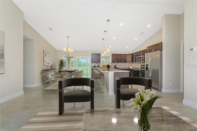 kitchen featuring backsplash, dark brown cabinetry, light tile patterned floors, a center island, and stainless steel appliances