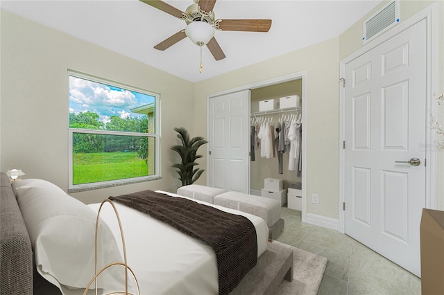 tiled bedroom with a closet and ceiling fan