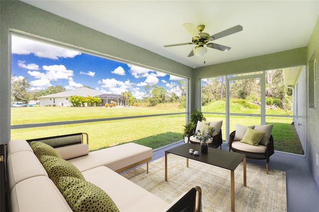 sunroom / solarium featuring ceiling fan