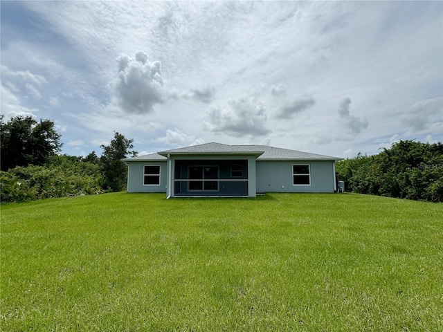 back of property featuring a lawn