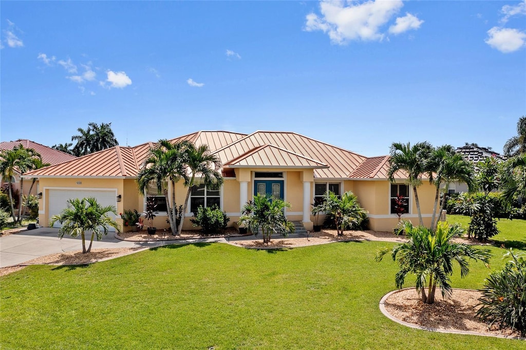 view of front of home featuring a front yard and a garage