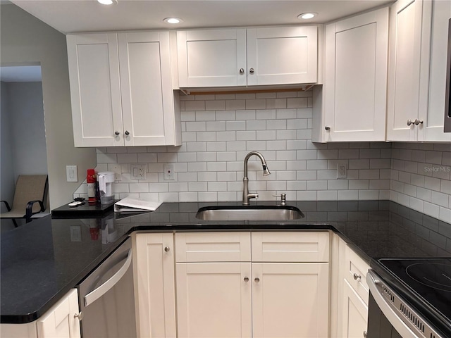 kitchen with sink, white cabinets, stainless steel dishwasher, and backsplash