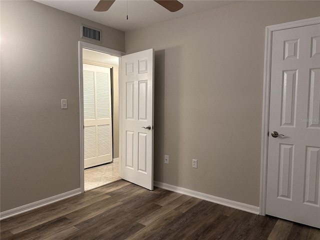 spare room with ceiling fan and dark hardwood / wood-style flooring