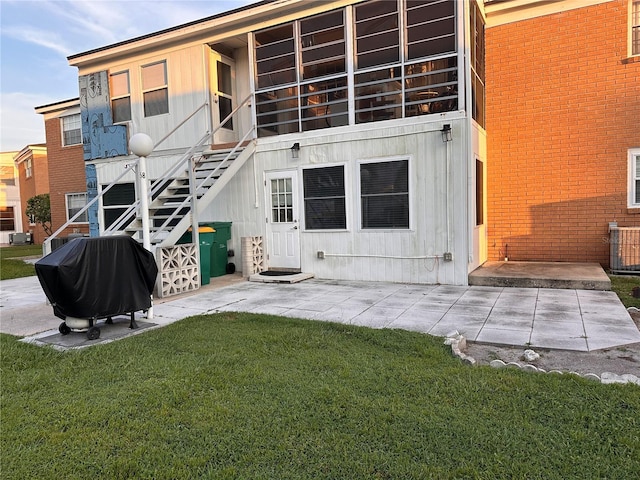 back of house featuring a patio area and a yard