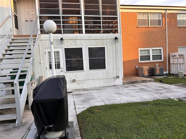 property entrance with a patio and central AC