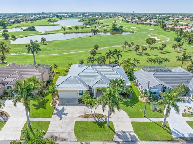 bird's eye view with golf course view, a water view, and a residential view