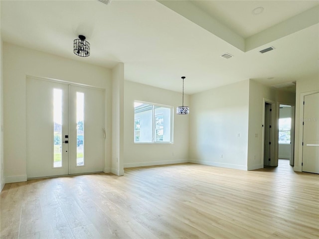 entryway with a chandelier and light hardwood / wood-style flooring