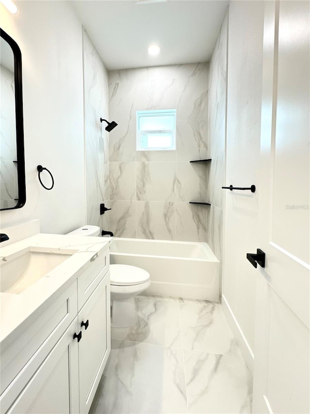 full bathroom featuring vanity, tiled shower / bath, and toilet