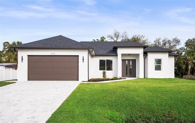 prairie-style house with a front yard and a garage