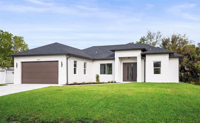 prairie-style home with a front yard and a garage