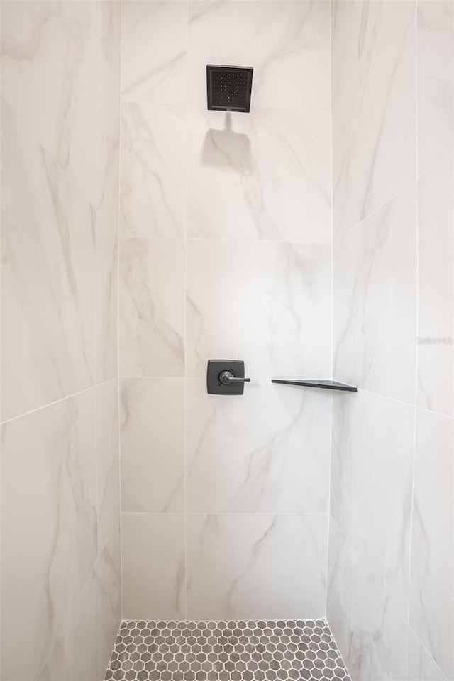 bathroom with tiled shower