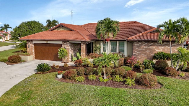 mediterranean / spanish home with a front yard and a garage