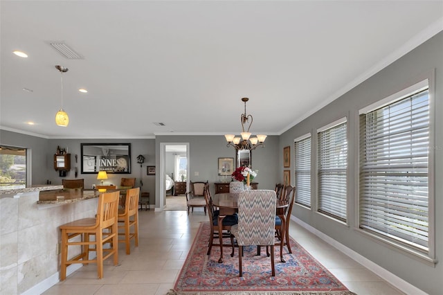 dining room featuring light tile patterned floors, ornamental molding, and a notable chandelier