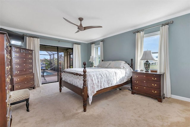 carpeted bedroom featuring multiple windows, ceiling fan, ornamental molding, and access to exterior