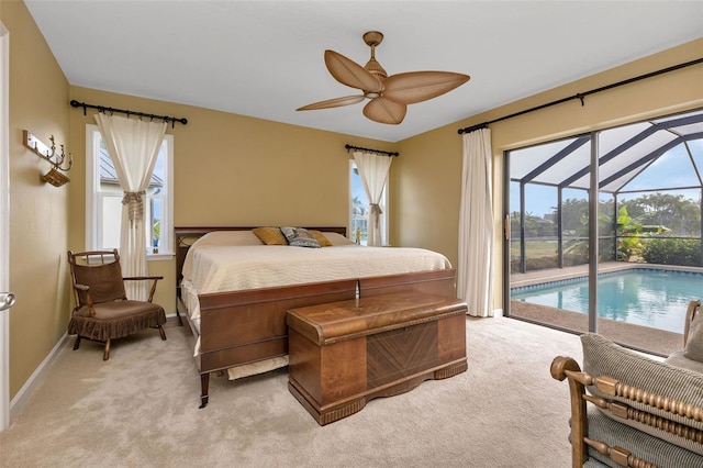 bedroom featuring access to exterior, ceiling fan, light carpet, and multiple windows