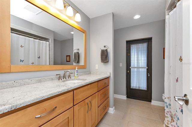 bathroom featuring tile patterned flooring and vanity