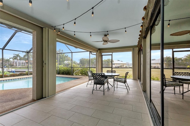 sunroom with plenty of natural light and ceiling fan