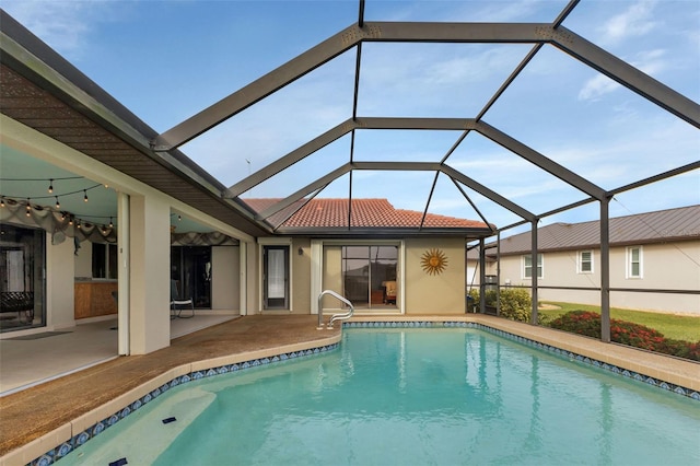 view of pool with a lanai and a patio