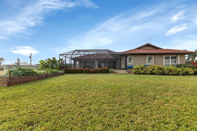 back of house with a lanai and a yard