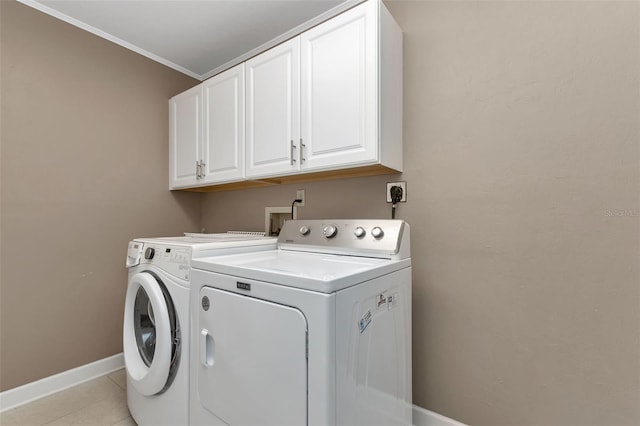 washroom featuring cabinets, light tile patterned floors, crown molding, and washing machine and clothes dryer