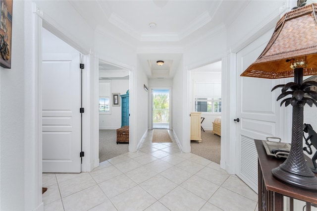 corridor featuring light colored carpet and ornamental molding