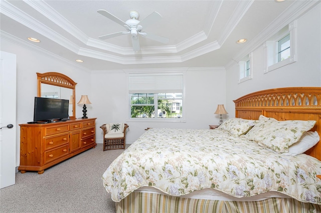 bedroom featuring a tray ceiling, ceiling fan, crown molding, and light colored carpet