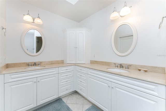 bathroom featuring tile patterned floors, vanity, and lofted ceiling