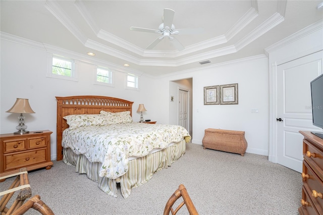 bedroom featuring ceiling fan, ornamental molding, carpet floors, and a tray ceiling