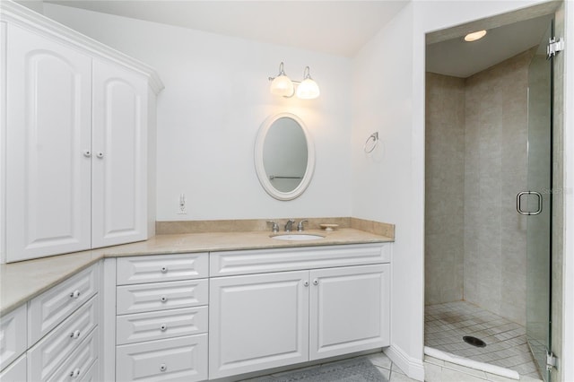 bathroom featuring tile patterned flooring, vanity, and a shower with shower door